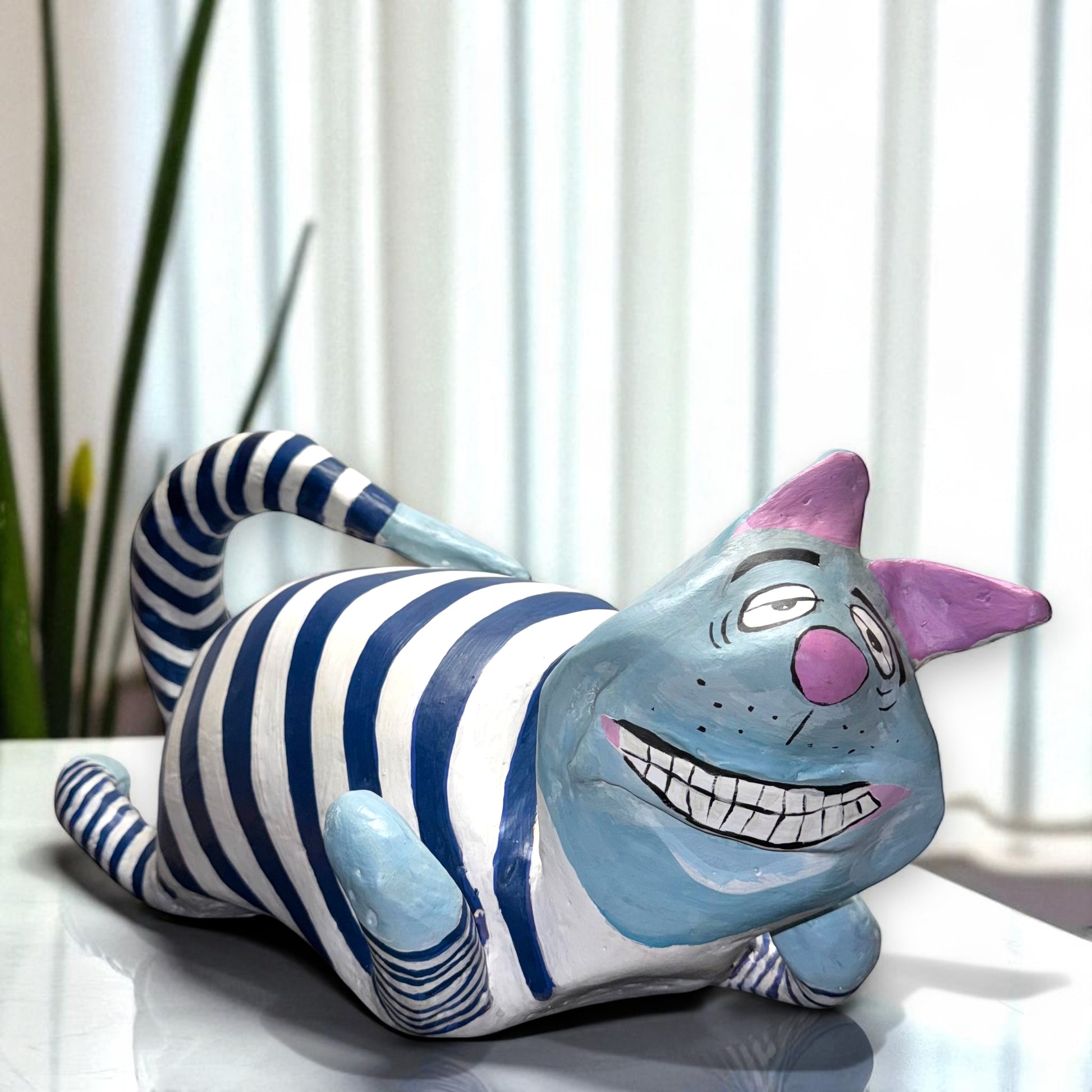 Striped cat figurine with a smiling face 