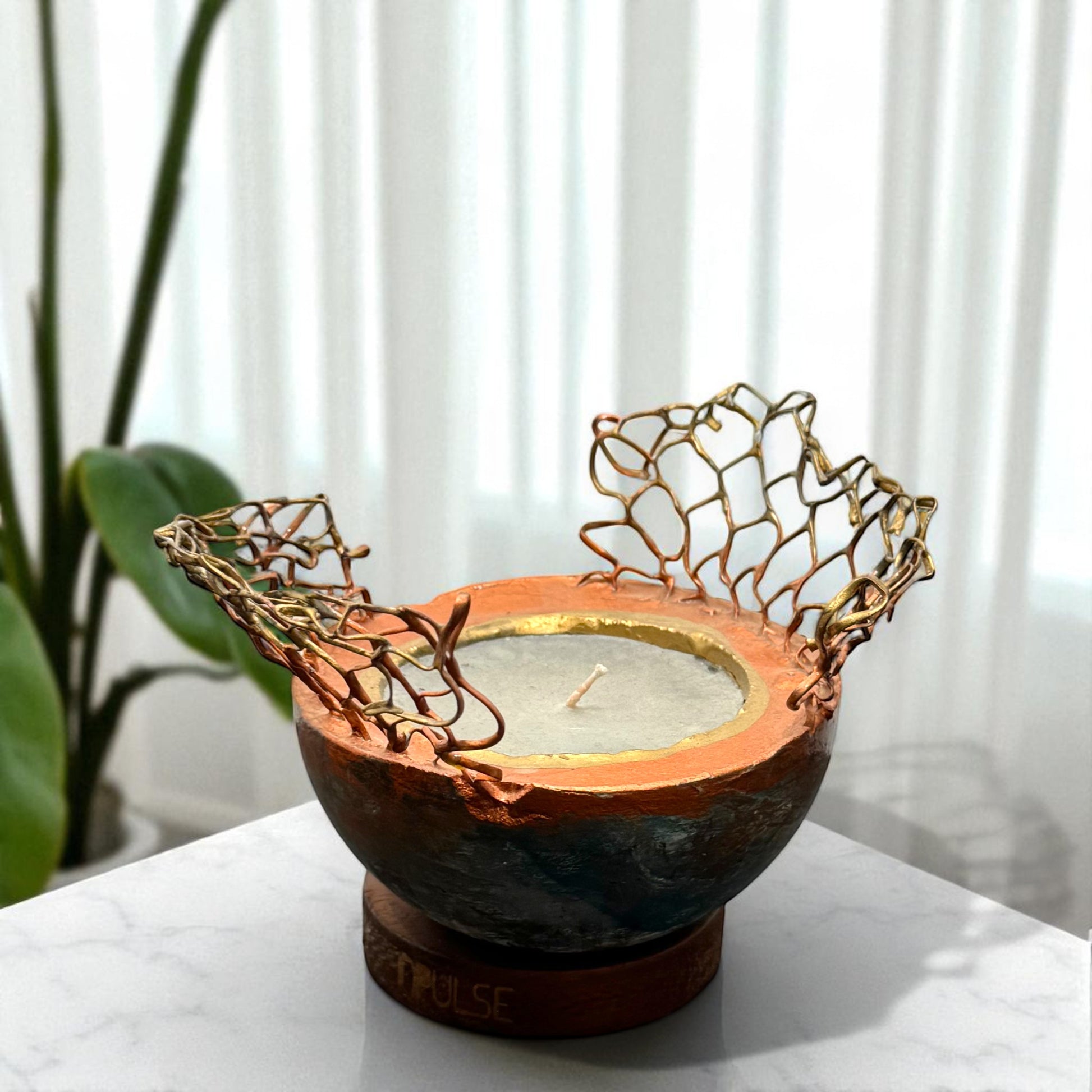 Candle holder with decorative metalwork 