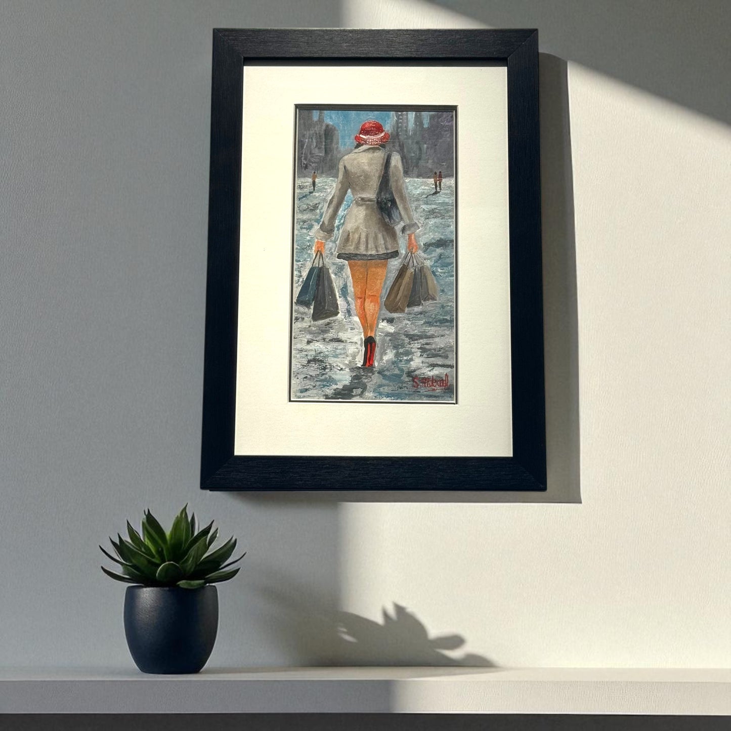 Framed artwork of a Lady with shopping bags 